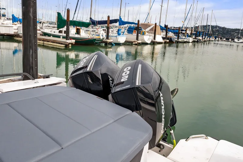 Slide: The Image of Axopar 28 Cabin 2021 with twin Mercury outboard engines docked at marina. - 10