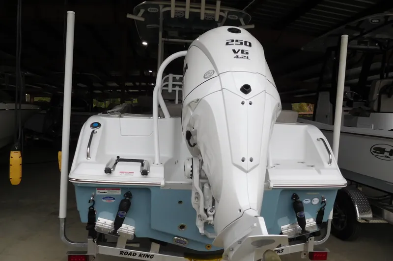 The Image of 2026 Sea Hunt Ultra 235SE boat with powerful 250 V6 engine in storage. - 1