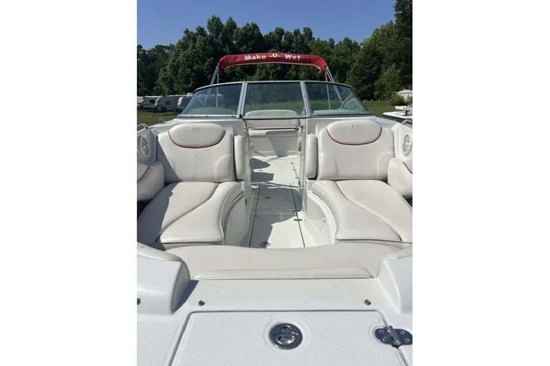 Slide: The Image of 2004 Crownline 240 EX boat interior with white seating and red accents. - 6