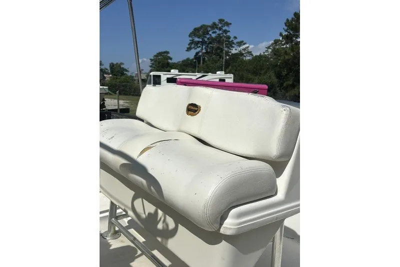 Slide: The Image of White seating on a 2004 Crownline 240 EX boat under clear blue sky. - 7