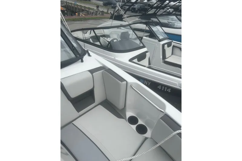 Slide: The Image of 2025 Yamaha Boats AR220 interior with seating and cup holders. - 11
