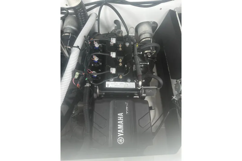 Slide: The Image of Engine compartment of 2025 Yamaha Boats AR220, showcasing intricate wiring and components. - 17