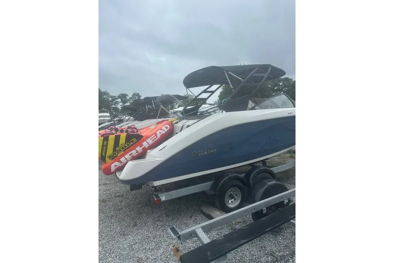Slide: The Image of 2025 Yamaha Boats AR220 on trailer with Airhead inflatable, overcast sky. - 3