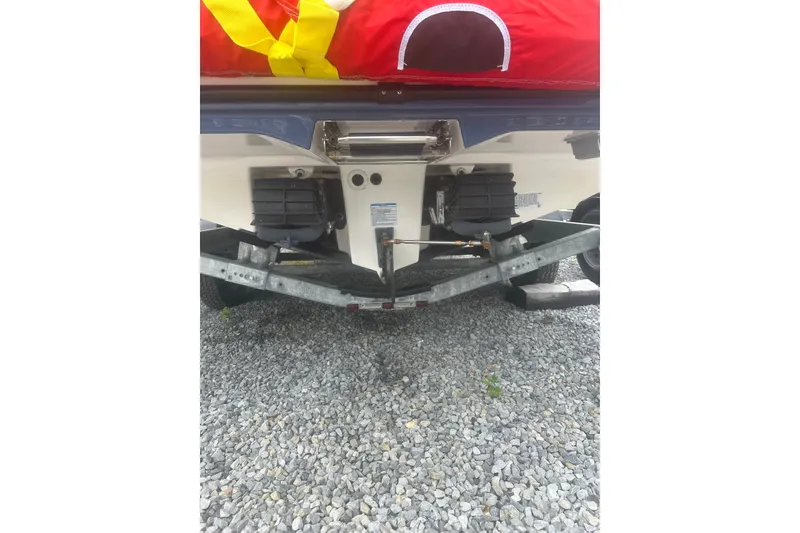 Slide: The Image of Rear view of 2025 Yamaha Boats AR220 on a trailer, showcasing dual engines. - 12
