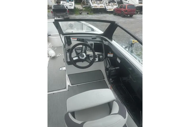 Slide: The Image of 2025 Yamaha Boats AR220 cockpit with steering wheel and dashboard controls. - 6
