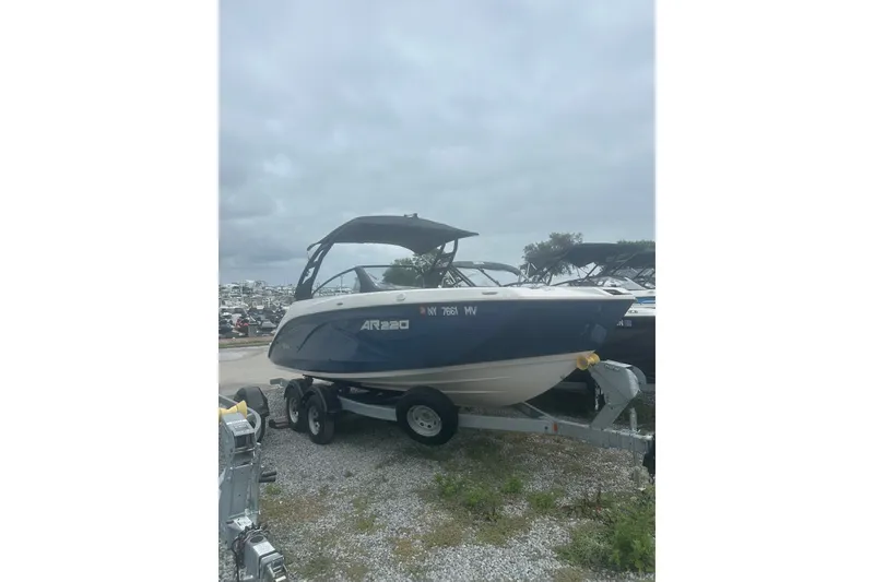 The Image of 2025 Yamaha Boats AR220 on trailer under cloudy sky. - 0