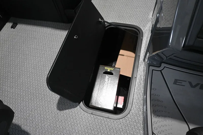 Slide: The Image of An open storage compartment in a boat's floor reveals boxes and other items. - 17