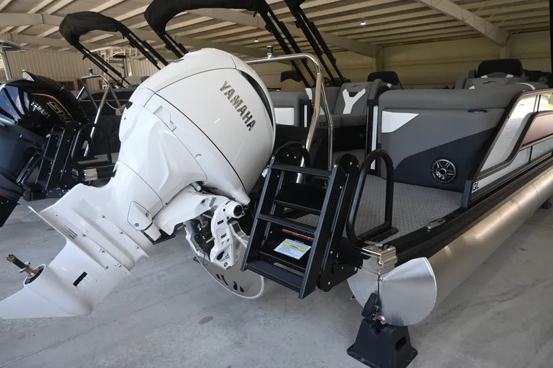 Slide: The Image of A 2027 Evotti 521QL pontoon boat with a large white outboard motor in a warehouse. - 4
