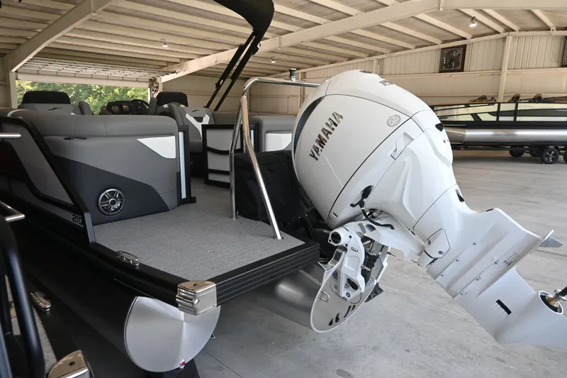 Slide: The Image of An Evotti 521QL pontoon boat with a Yamaha outboard motor in a storage facility. - 5