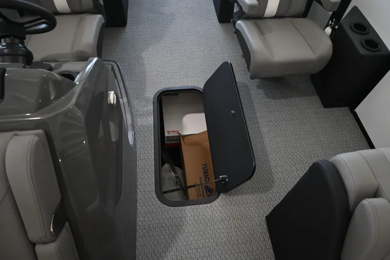 Slide: The Image of The image shows a boat interior with gray seating and an open floor compartment. - 15