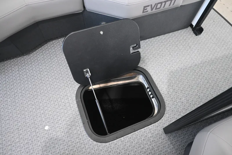 Slide: The Image of An Evotti 521QL boat with an open floor compartment on a textured carpeted floor. - 14