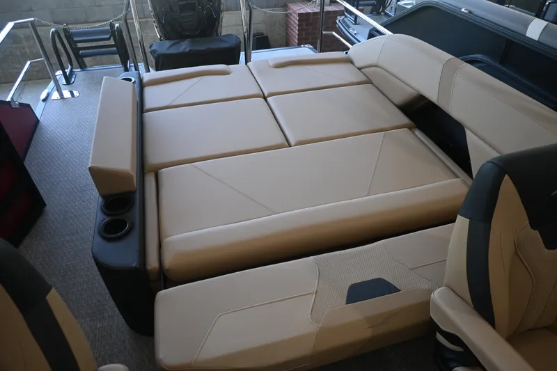 Slide: The Image of The image shows the interior of a 2027 Evotti 521CS with beige upholstery and cup holders. - 15