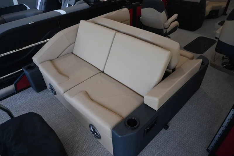Slide: The Image of The image shows a beige leather bench seat on a boat, surrounded by black armrests with cup holders. - 17