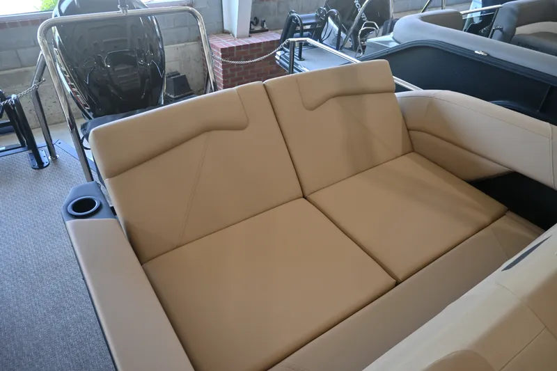 Slide: The Image of The image shows a beige seating area in a modern boat, surrounded by metal railings. - 16
