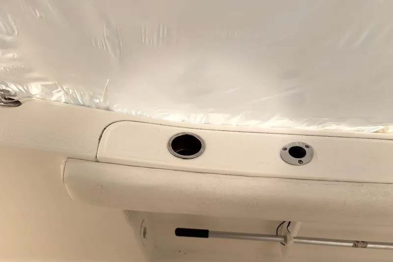 Slide: The Image of Interior view of a 2014 Sea Fox 226 Commander boat, featuring rod holders. - 15