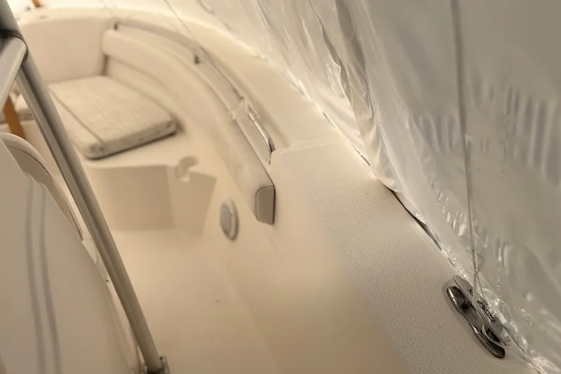 Slide: The Image of Interior view of a 2014 Sea Fox 226 Commander boat, featuring seating and railing. - 16