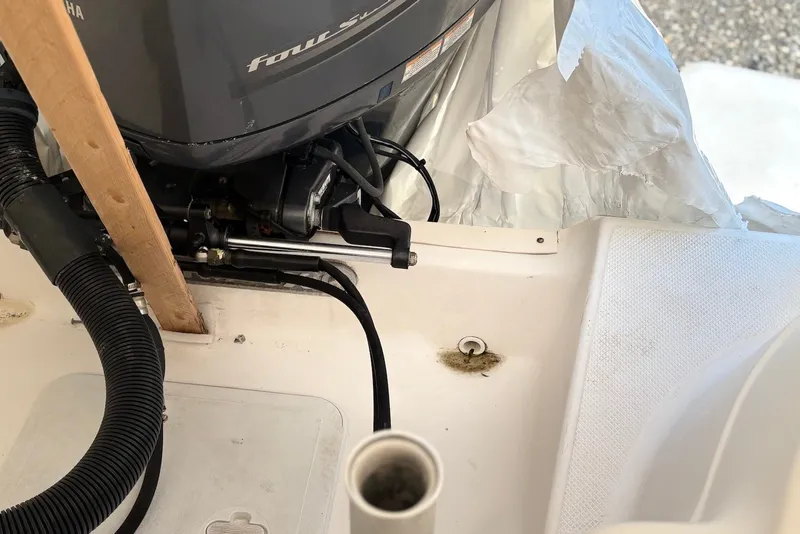 Slide: The Image of 2014 Sea Fox 226 Commander boat engine area with Yamaha motor and protective cover. - 17