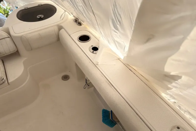 Slide: The Image of Interior view of a 2014 Sea Fox 226 Commander boat, featuring seating and storage areas. - 13