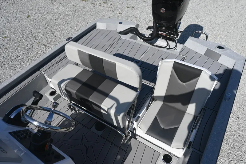 Slide: The Image of The image shows the cockpit of a Vexus ACX2000 boat with two seats and an outboard motor. - 13