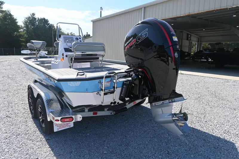 Slide: The Image of A 2027 Vexus ACX2000 boat on a trailer outside a warehouse. - 3