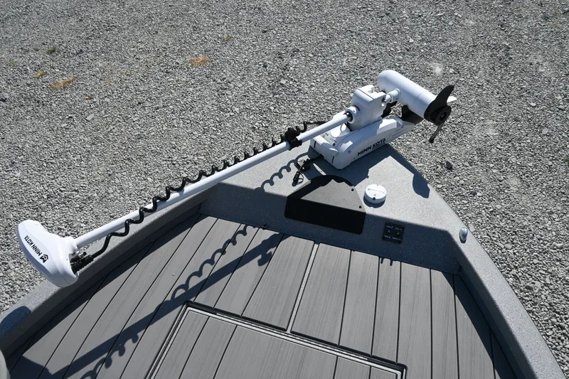 Slide: The Image of The image shows the bow deck of a Vexus ACX2000 boat with a mounted electric motor. - 11