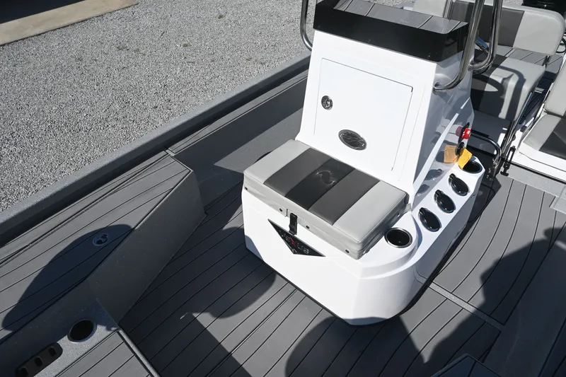 Slide: The Image of The image shows the cockpit of a Vexus ACX2000 boat with gray flooring and storage space. - 12