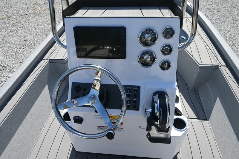 Slide: The Image of The image shows the helm of a Vexus ACX2000 boat with a steering wheel and gauges. - 9