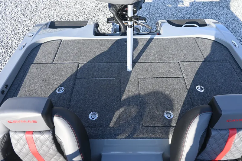 Slide: The Image of The image shows the deck of a Caymas 201 Pro boat with gray carpeting and two seats. - 10