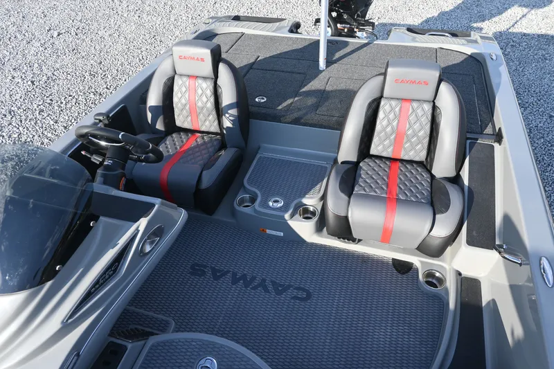 Slide: The Image of The image shows the cockpit of a Caymas 201 Pro boat with two padded seats and a steering wheel. - 8