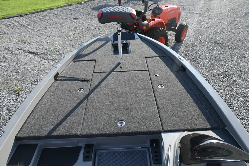 Slide: The Image of The image shows the deck of a Caymas 201 Pro boat with gray carpeting and a tractor in the background. - 7