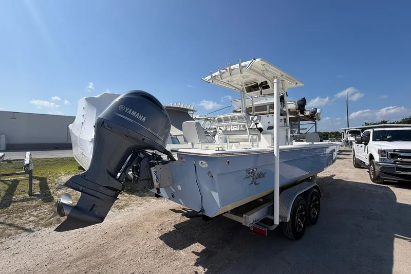 Slide: The Image of 2021 KenCraft BAYRIDER 2260FS boat with Yamaha engine on trailer, parked outdoors. - 2