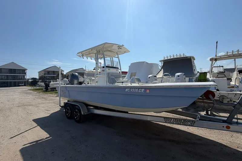 The Image of 2021 KenCraft BAYRIDER 2260FS boat on trailer in sunny marina setting. - 1