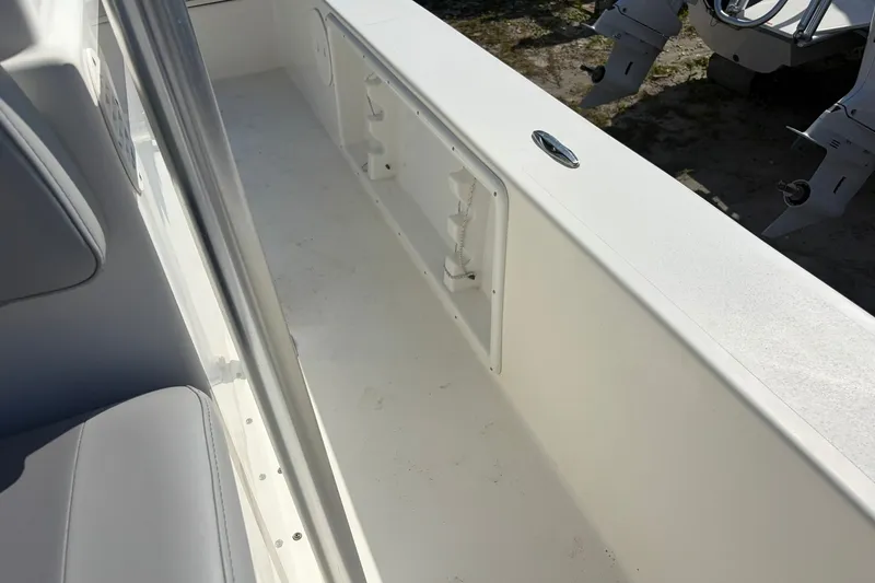 Slide: The Image of 2021 KenCraft BAYRIDER 2260FS boat interior with seating and storage compartments. - 17