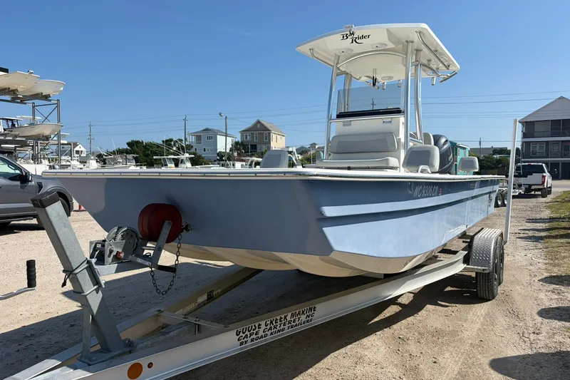 Slide: The Image of 2021 KenCraft BAYRIDER 2260FS boat on trailer in sunny marina setting. - 3
