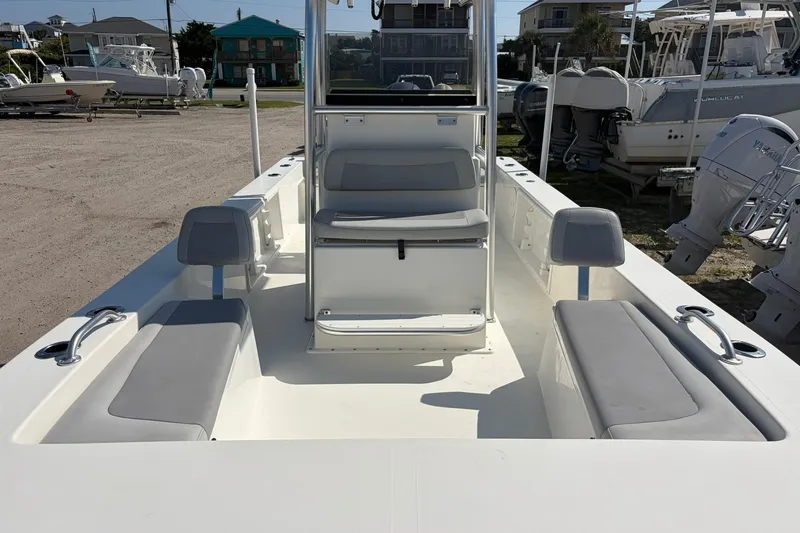 Slide: The Image of 2021 KenCraft BAYRIDER 2260FS boat interior with seating and console, docked outdoors. - 15