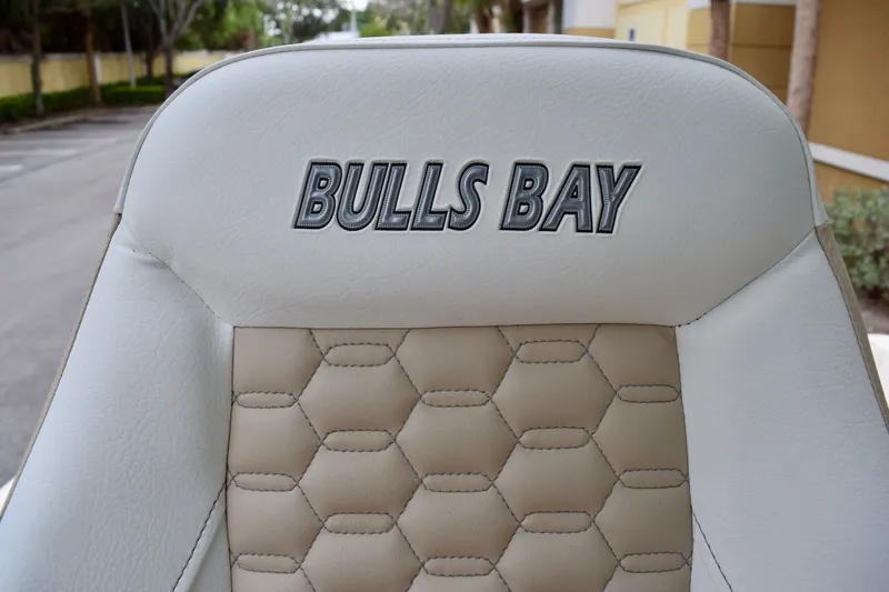 Slide: The Image of 2027 Bulls Bay 255 Center Console boat seat with logo and hexagonal stitching. - 13