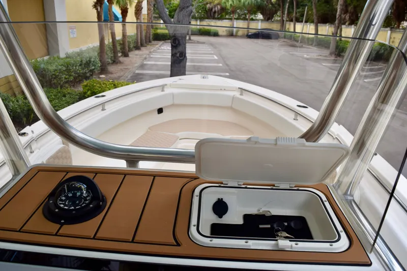 Slide: The Image of 2027 Bulls Bay 255 Center Console boat interior with compass and storage compartment. - 14