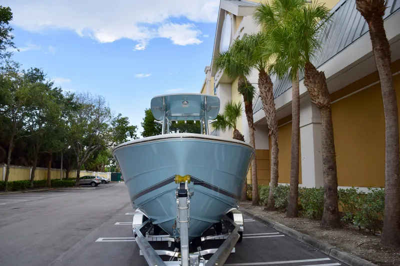 Slide: The Image of 2027 Bulls Bay 255 Center Console boat on trailer, parked near palm trees. - 16