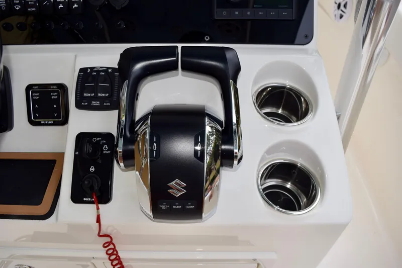 Slide: The Image of 2027 Bulls Bay 255 Center Console boat controls with Suzuki throttle and cup holders. - 15
