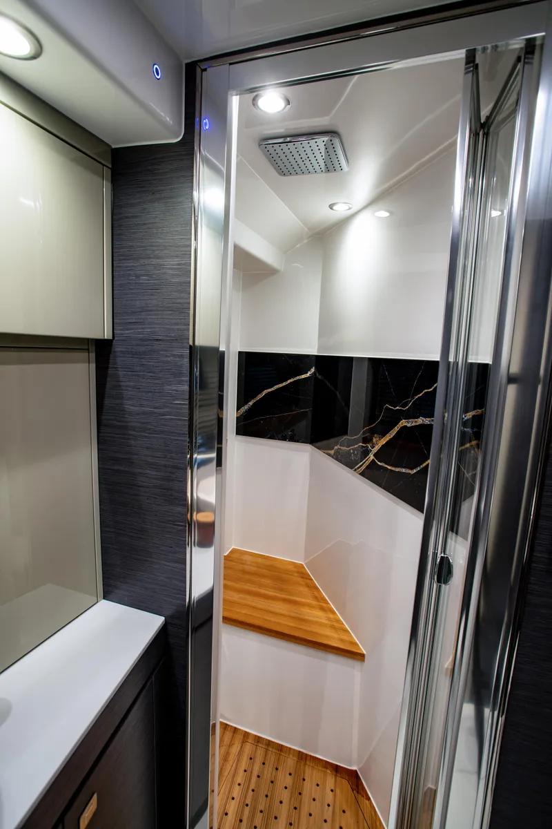 Slide: The Image of Interior of 2025 Cobrey 45 FLY yacht, featuring modern bathroom design with wood accents. - 13