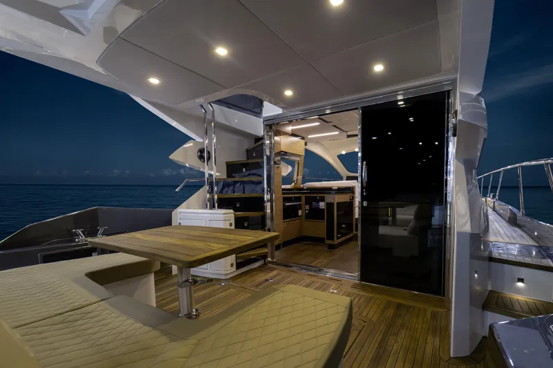 Slide: The Image of Luxurious 2025 Cobrey 52 FLY yacht interior with elegant seating and modern kitchen. - 9