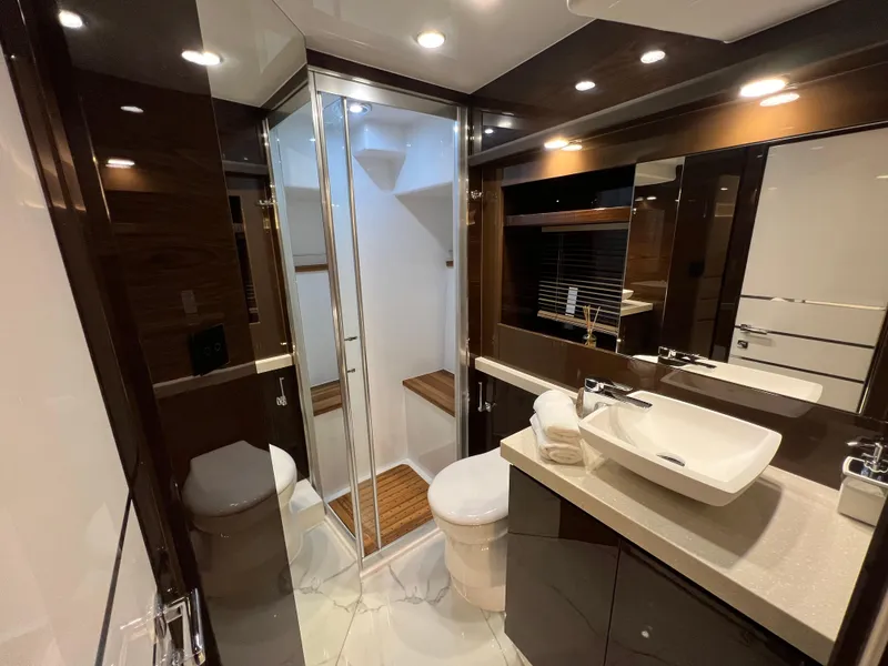Slide: The Image of Luxurious bathroom interior of 2025 Cobrey 52 FLY yacht, featuring modern fixtures and elegant design. - 14