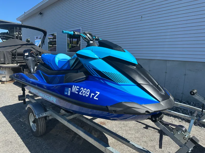 The Image of A blue 2023 Yamaha GP9 1800R jet ski on a trailer in front of a building. - 1