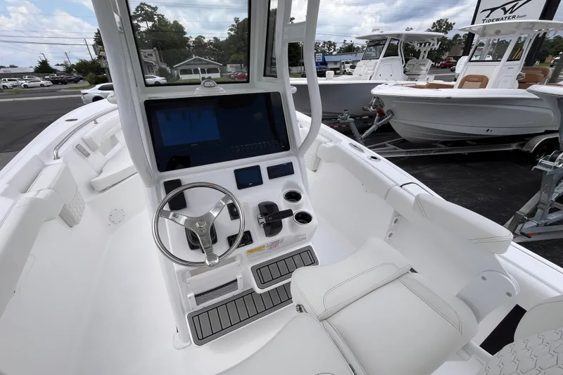 Slide: The Image of 2027 Tidewater 232 LXF boat interior with steering wheel and control panel. - 15
