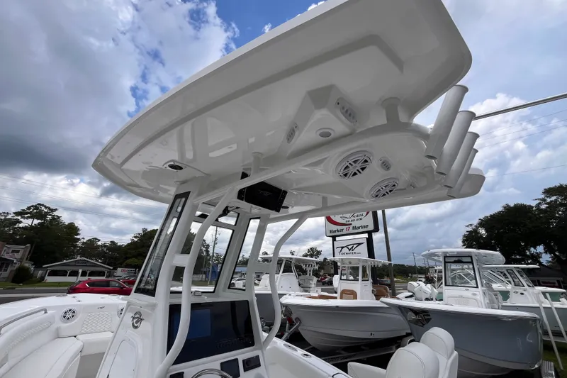 Slide: The Image of 2027 Tidewater 232 LXF boat with advanced console and speakers under cloudy sky. - 14