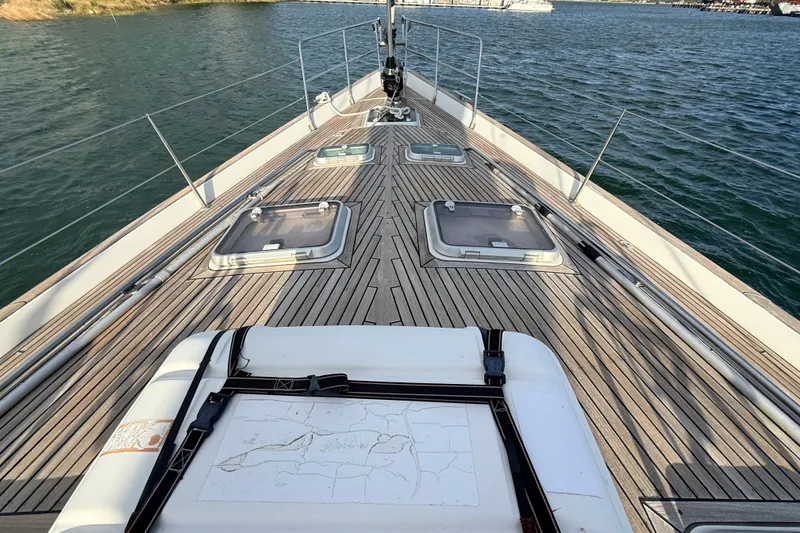 Slide: The Image of Deck view of 2005 Beneteau 57 yacht with teak finish and hatches. - 33