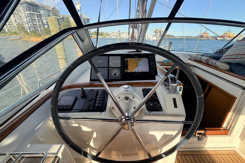 Slide: The Image of Steering wheel and navigation controls on a 2005 Beneteau 57 sailboat. - 28
