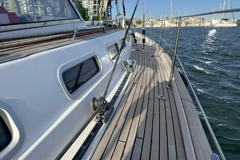 Slide: The Image of Deck view of a 2005 Beneteau 57 sailboat docked at a marina. - 35
