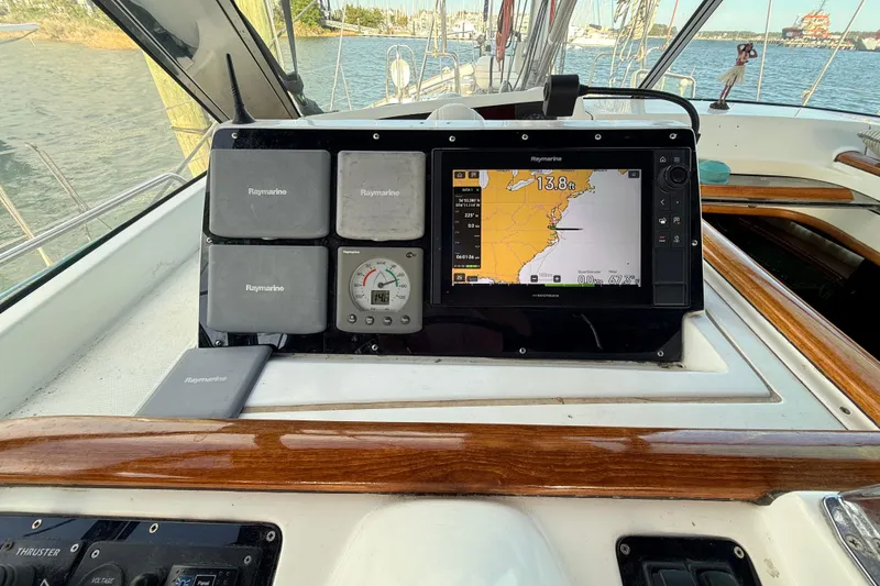 Slide: The Image of Beneteau 57 yacht cockpit with Raymarine navigation system, 2005 model, docked by the water. - 29