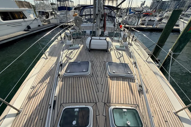 Slide: The Image of Deck view of a 2005 Beneteau 57 yacht docked at a marina. - 32